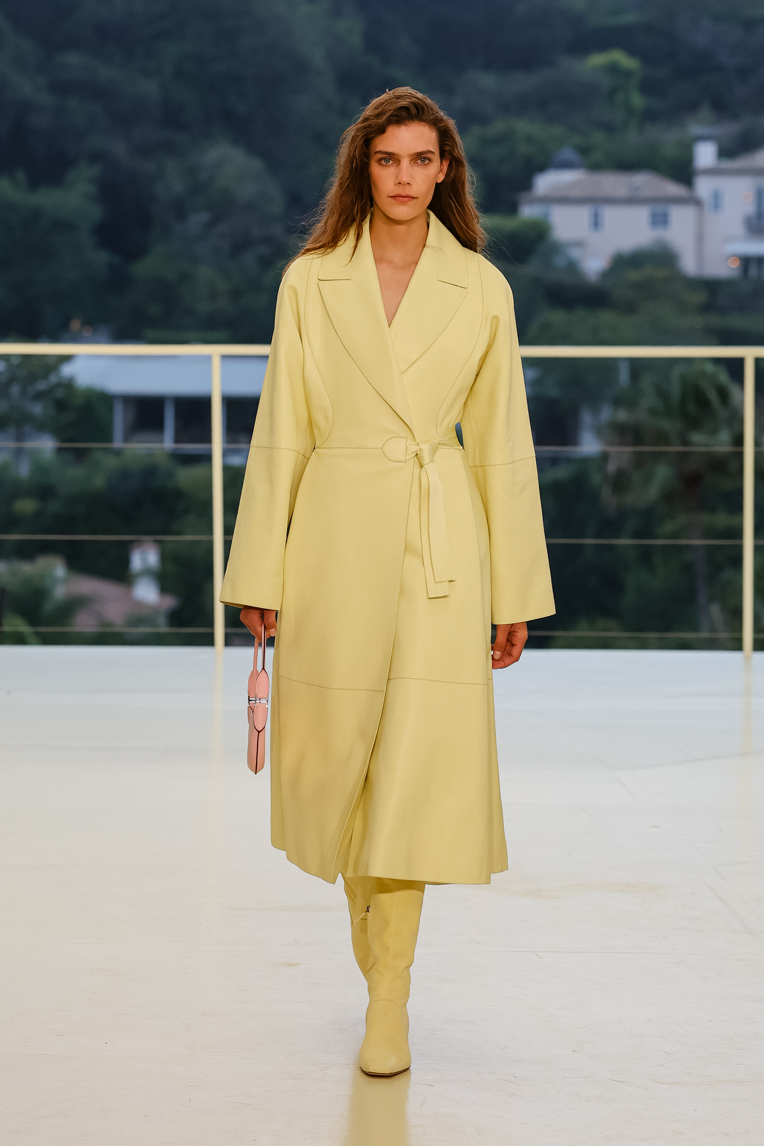 a woman wears a yellow jacket and yellow boot.