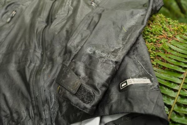 A soggy waterproof jacket on a forest floor