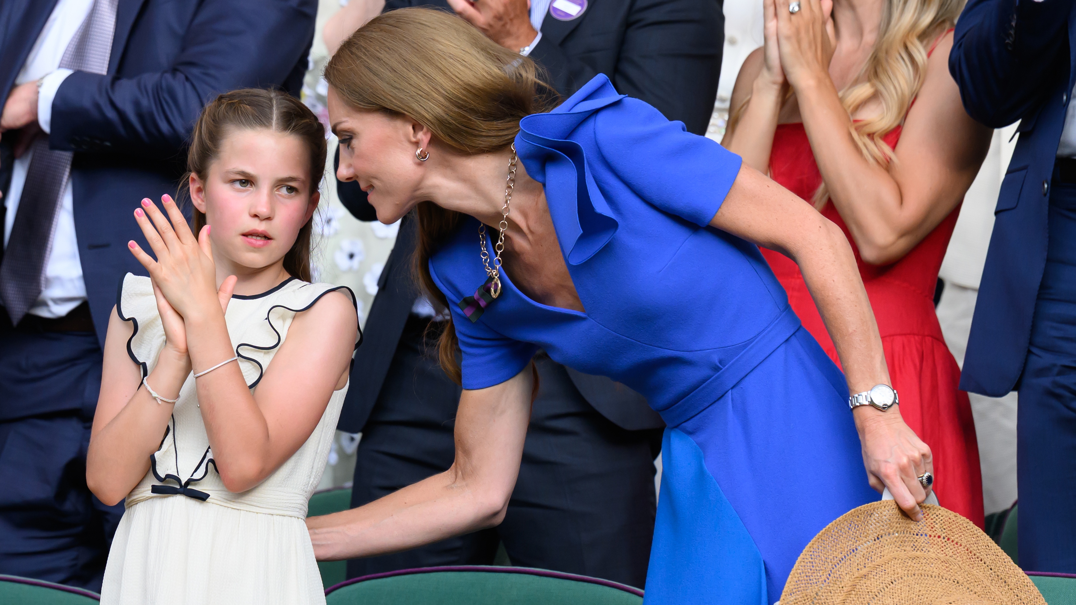 Catherine, Princess of Wales leans down to talk to Princess Charlotte at Wimbledon 2025