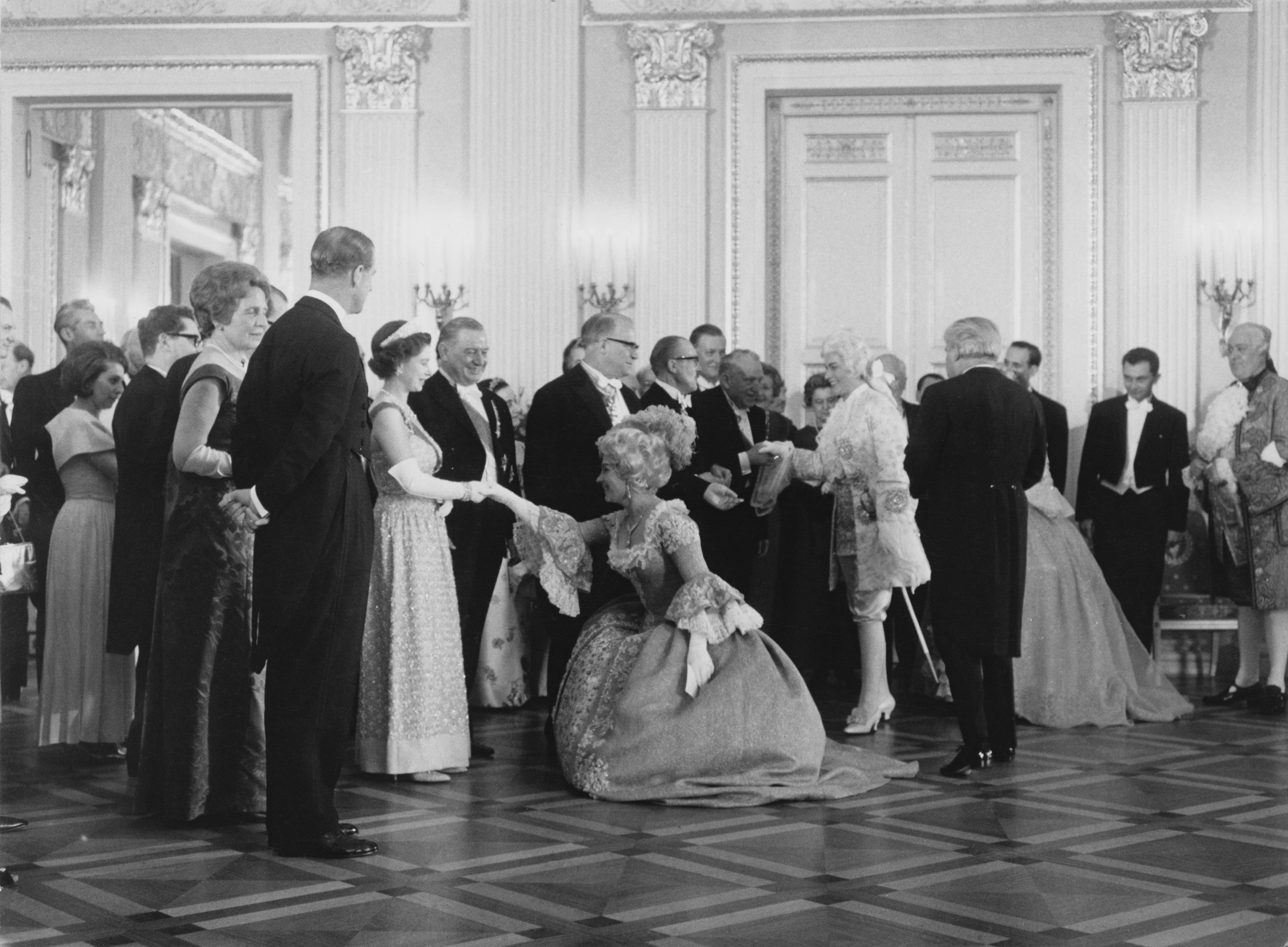 Queen Elizabeth II and Prince Philip (left) meet the cast of the Richard Strauss opera after a gala performance at the National Theatre, Munich, 24th May 1965.