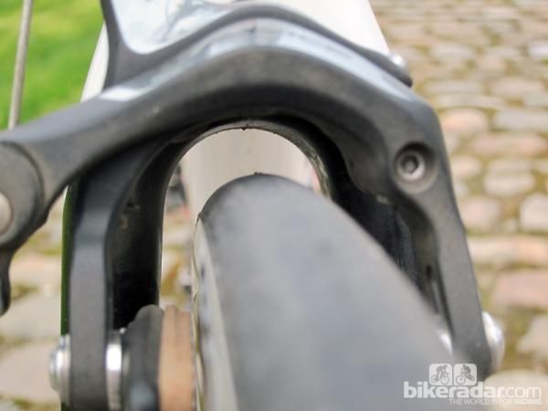 Maximum tire size is officially 25mm but it looks like 28mm ones will easily clear