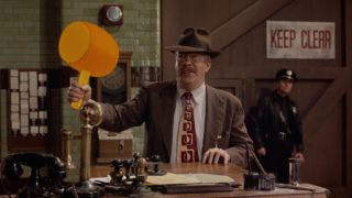 Joel Cutrara holds a cartoon mallet with a smile on his face at the Acme Warehouse in Who Framed Roger Rabbit.