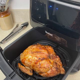 Image of air fryer with chicken inside