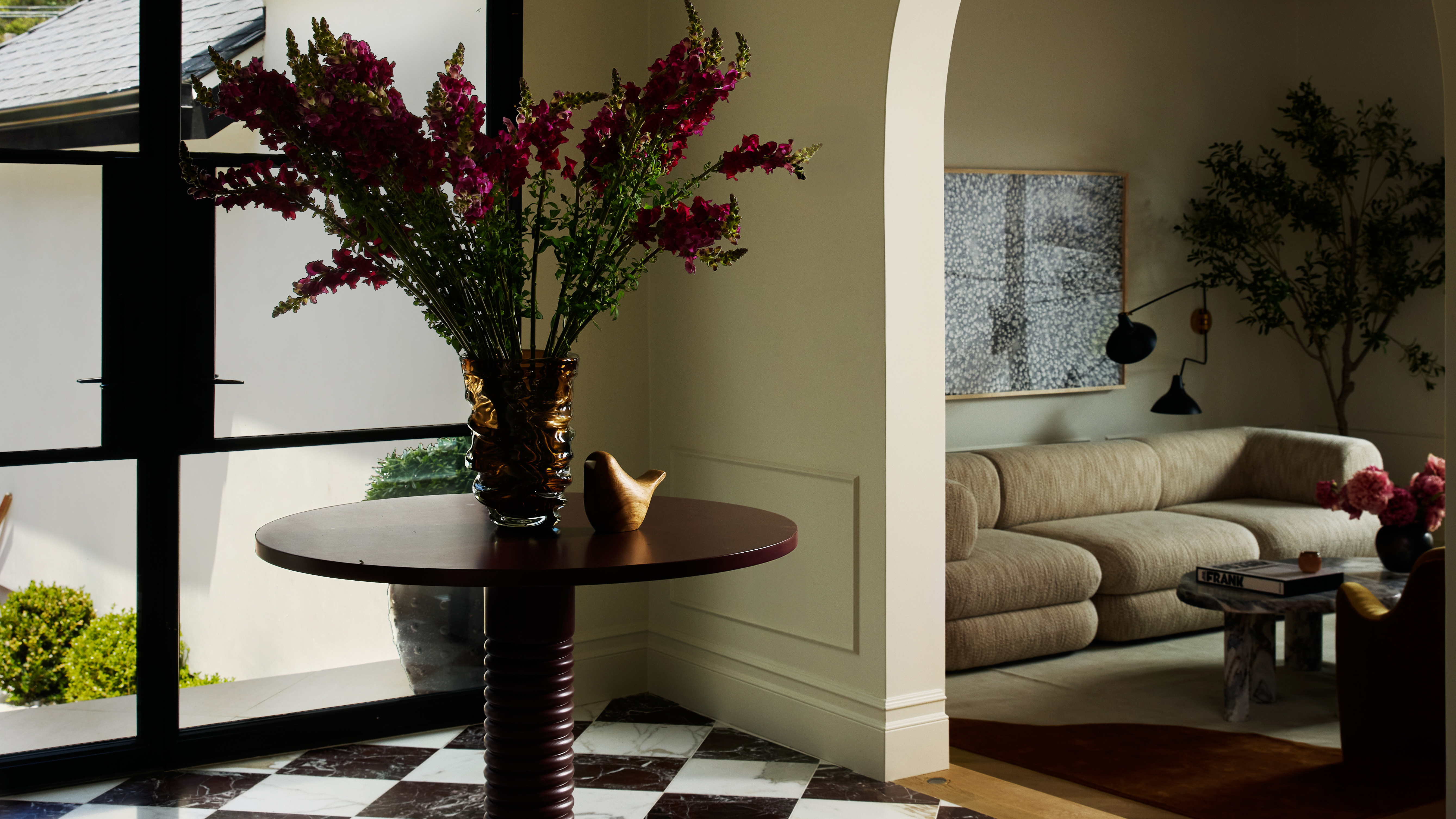 entryway with checkerboard floor and look through into the adjoining living room