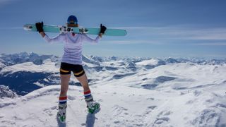 woman skier wearing shorts, socks and ski boots
