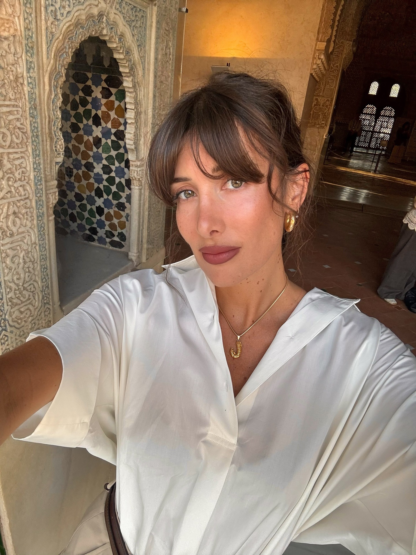 A woman taking photos with a light edge hairstyle