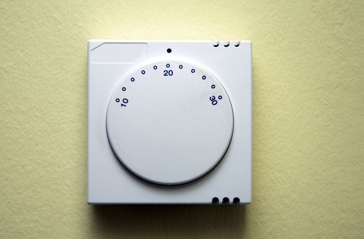 Thermostat on yellow background