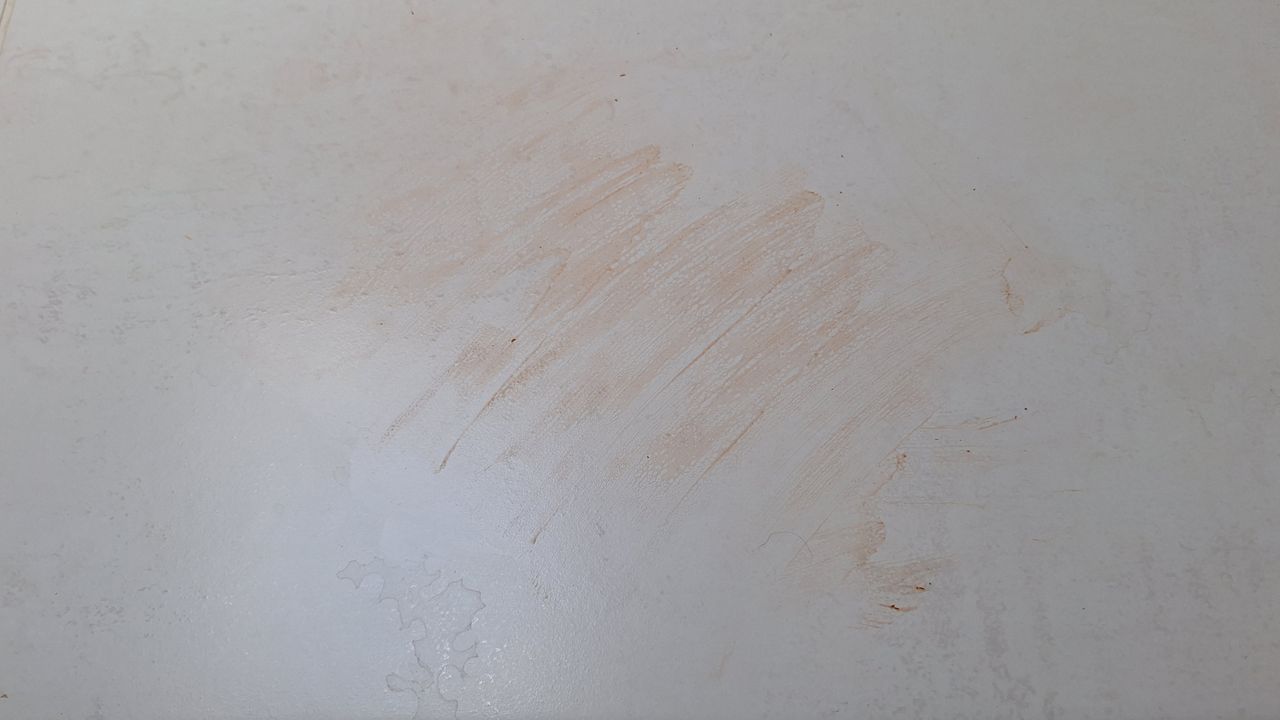 Tiled floor smeared with dry ketchup before mopping tests