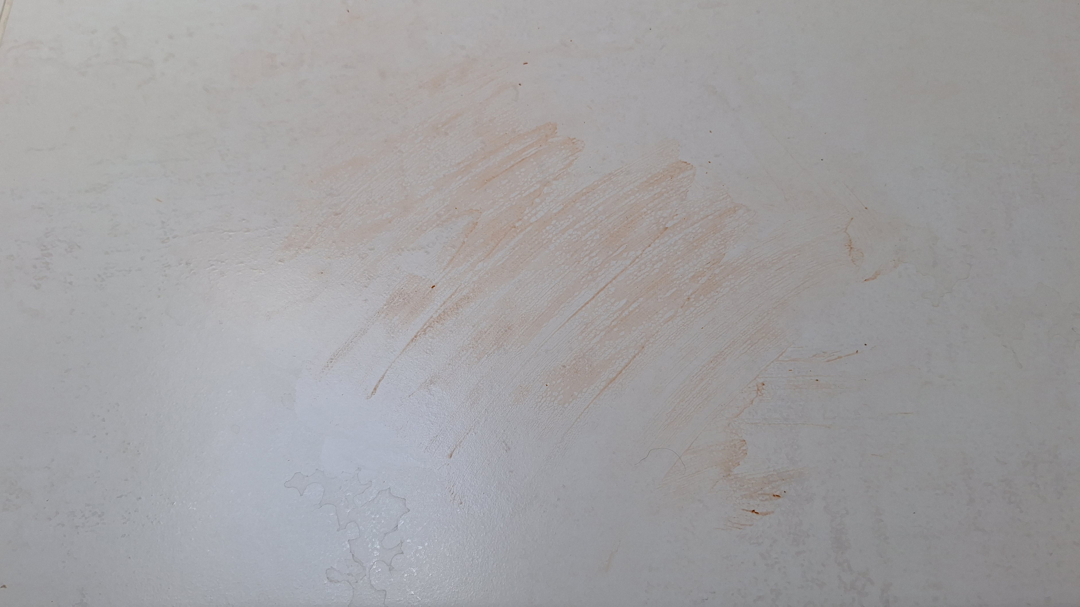 Tiled floor smeared with dry ketchup before mopping tests