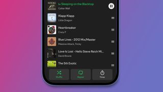 A phone on a pink and blue background showing the Spotify app's Queue in the Now Playing view