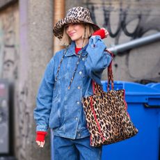 a woman wears a leopard-print hat and handbag