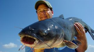 Man holding large catfish