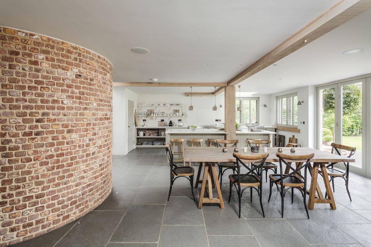 open plan kitchen and dining area with grey floor tiles