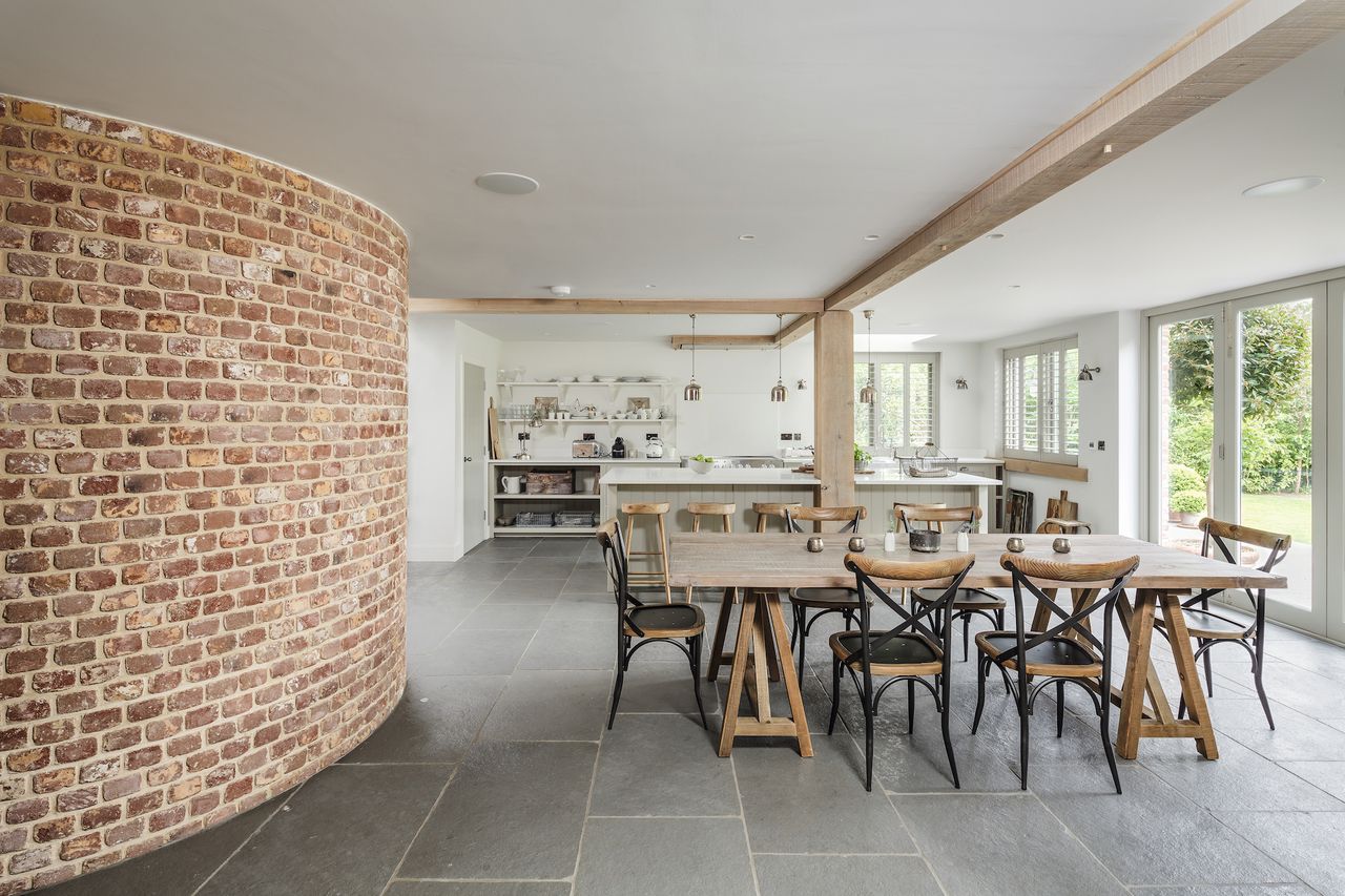 open plan kitchen and dining area with grey floor tiles