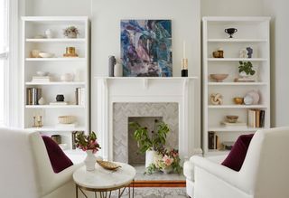 Small white living room with white armchairs