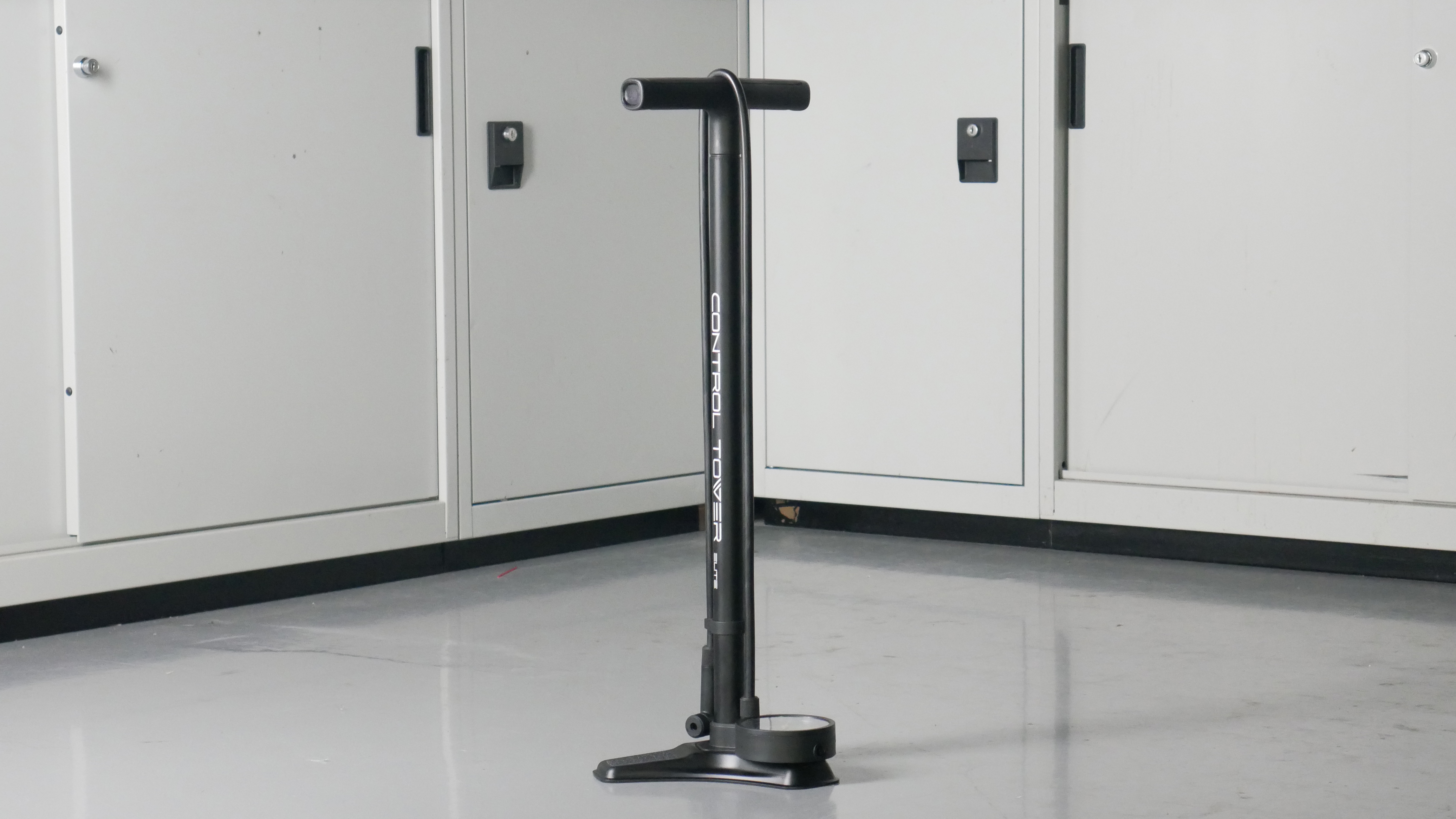 Giant Control Tower bike track pump in black set to a background of some workshop cabinets