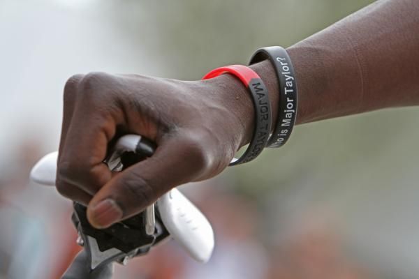The hand of Rahsaan Bahati featuring Major Taylor wristbands.