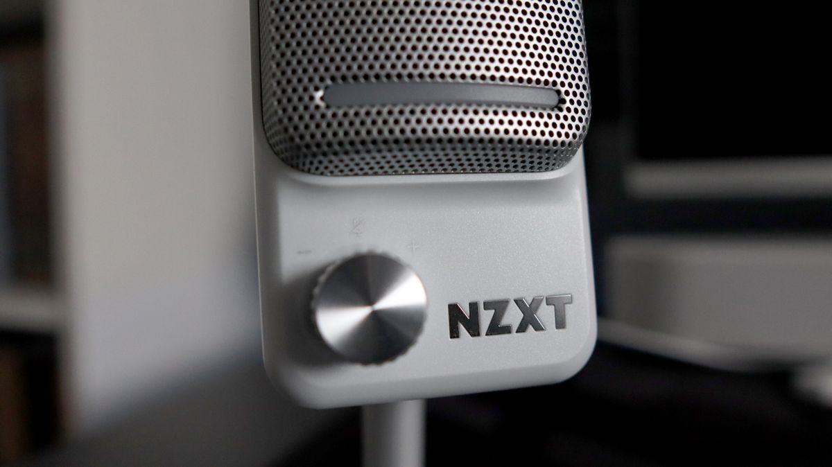 An NZXT Capsule Elite microphone set up on a desk with lighting enabled.