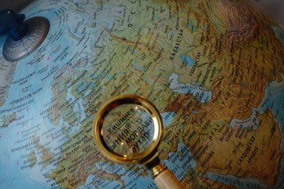 A magnifying glass and a globe.