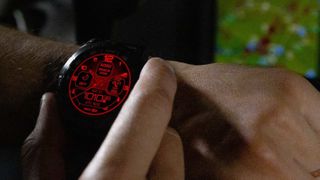 Man using Garmin D2 Mach 1 Pro watch in red shift mode