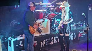 Joe Bonamassa and Orianthi live on stage playing guitar