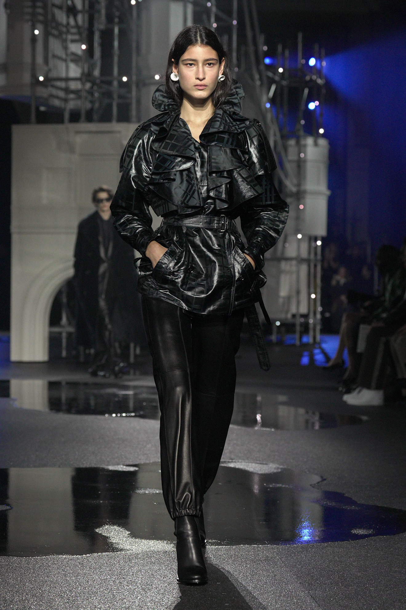 A model wears a high-neck jacket.