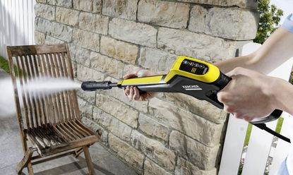 Kärcher K5 power control pressure washer being used on a chair