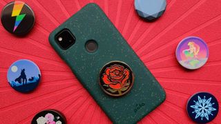 A bunch of nerdy-themed Popsockets surrounding a Pixel 4a
