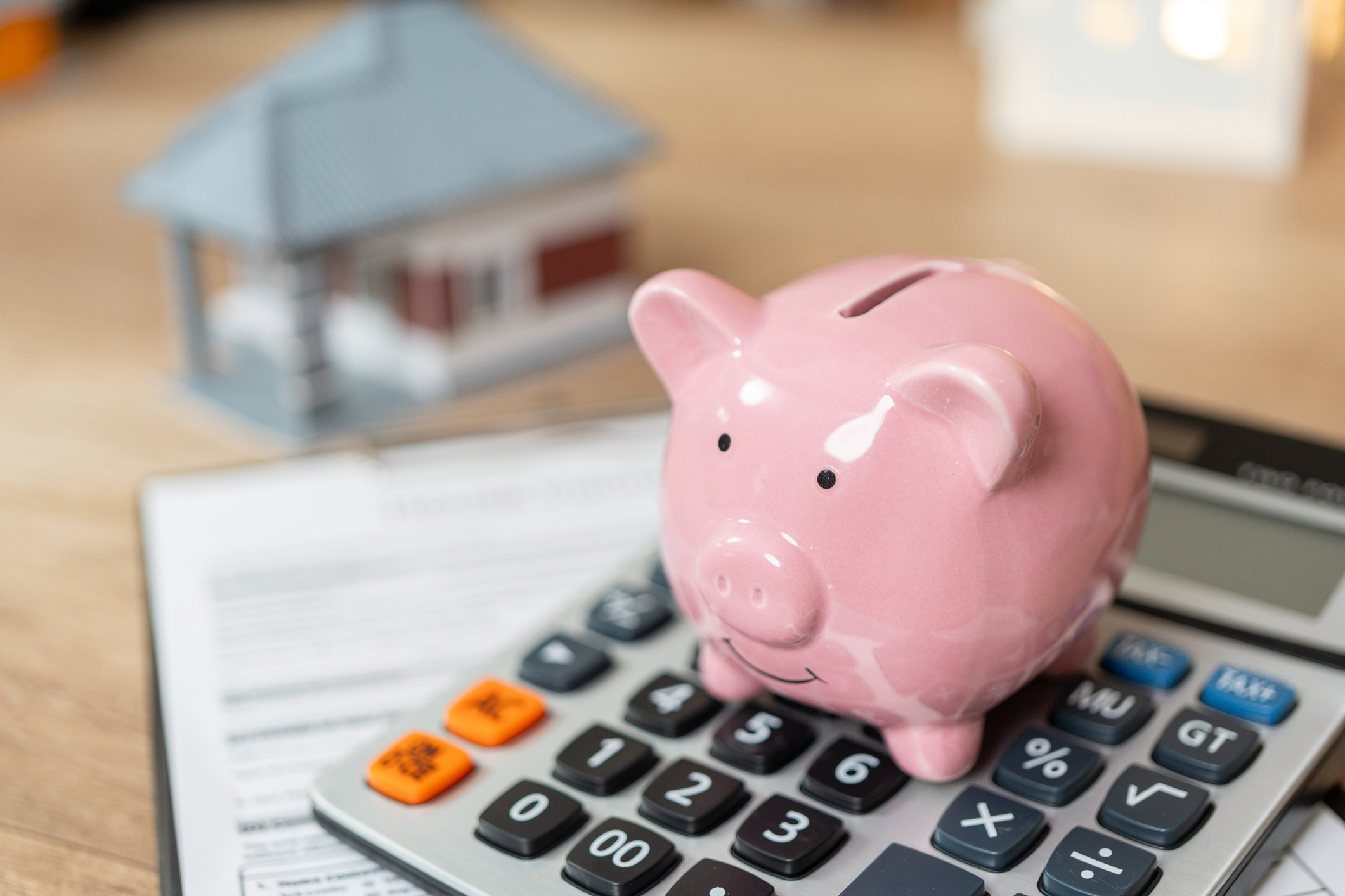 a piggy bank sitting on a calculator