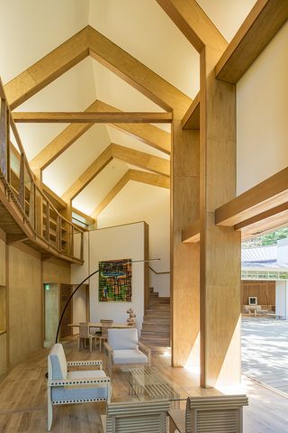 Seating area with high, A-frame ceiling and exposed beams