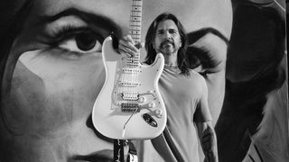 Juanes poses with his signature Fender Stratocaster electric guitar