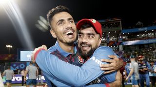 Mujeeb Ur Rahman and Rashid Khan of Afghanistan celebrate at the ICC Men's Cricket World Cup ahead of the crucial Australia vs Afghanistan match on Tuesday, Nov. 7 2023