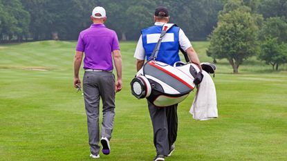 Generic image of a player and caddie walking on a fairway