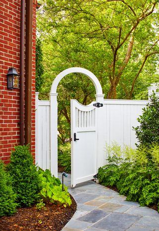 A tall fence with an entry door