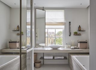 A bathroom with clever space-saving ideas, such as an overlapping vanity in front of a window