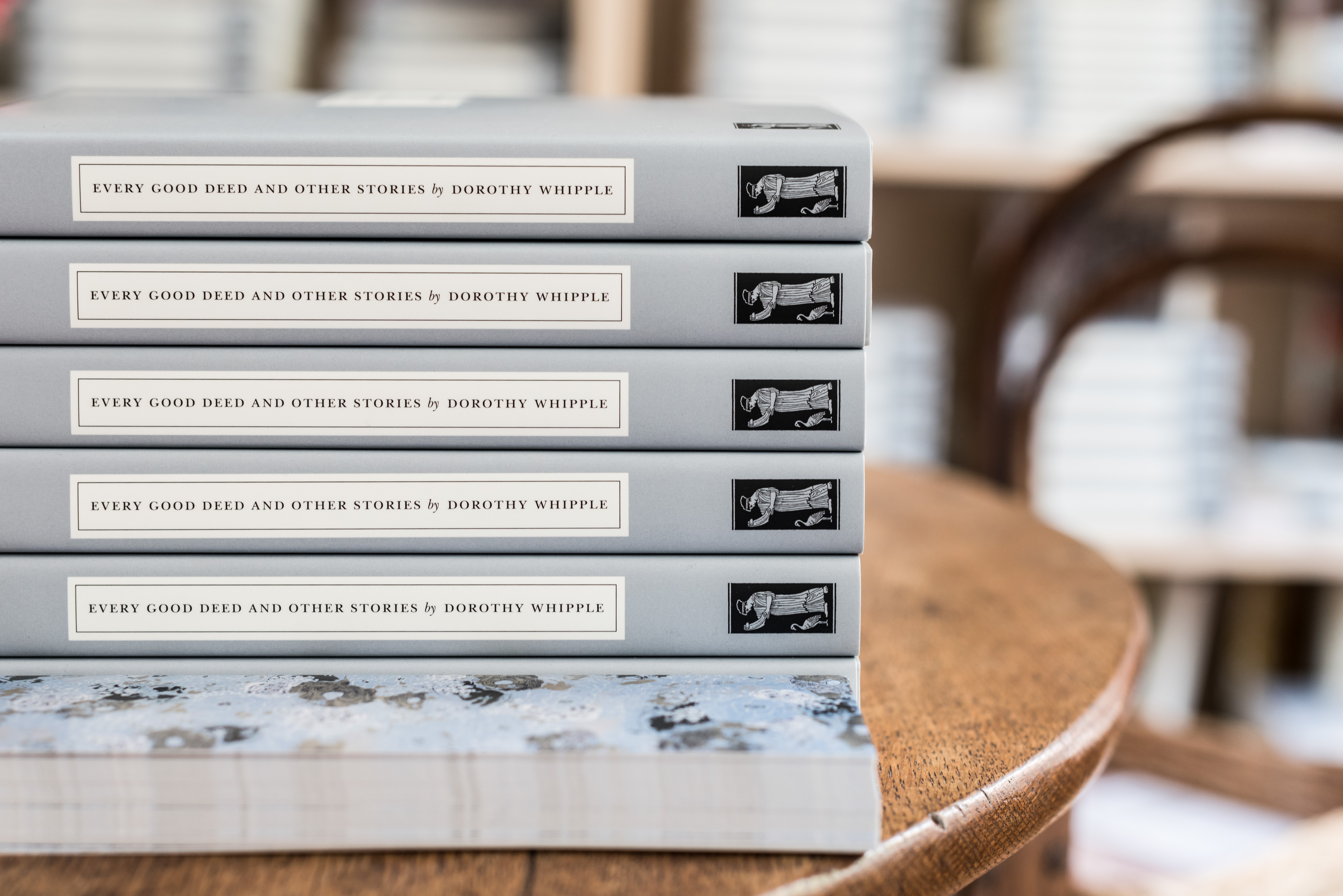 Persephone books with grey covers and colourful endpapers