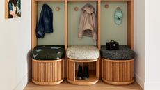 an entryway seating area with tambour doors to hide shoes