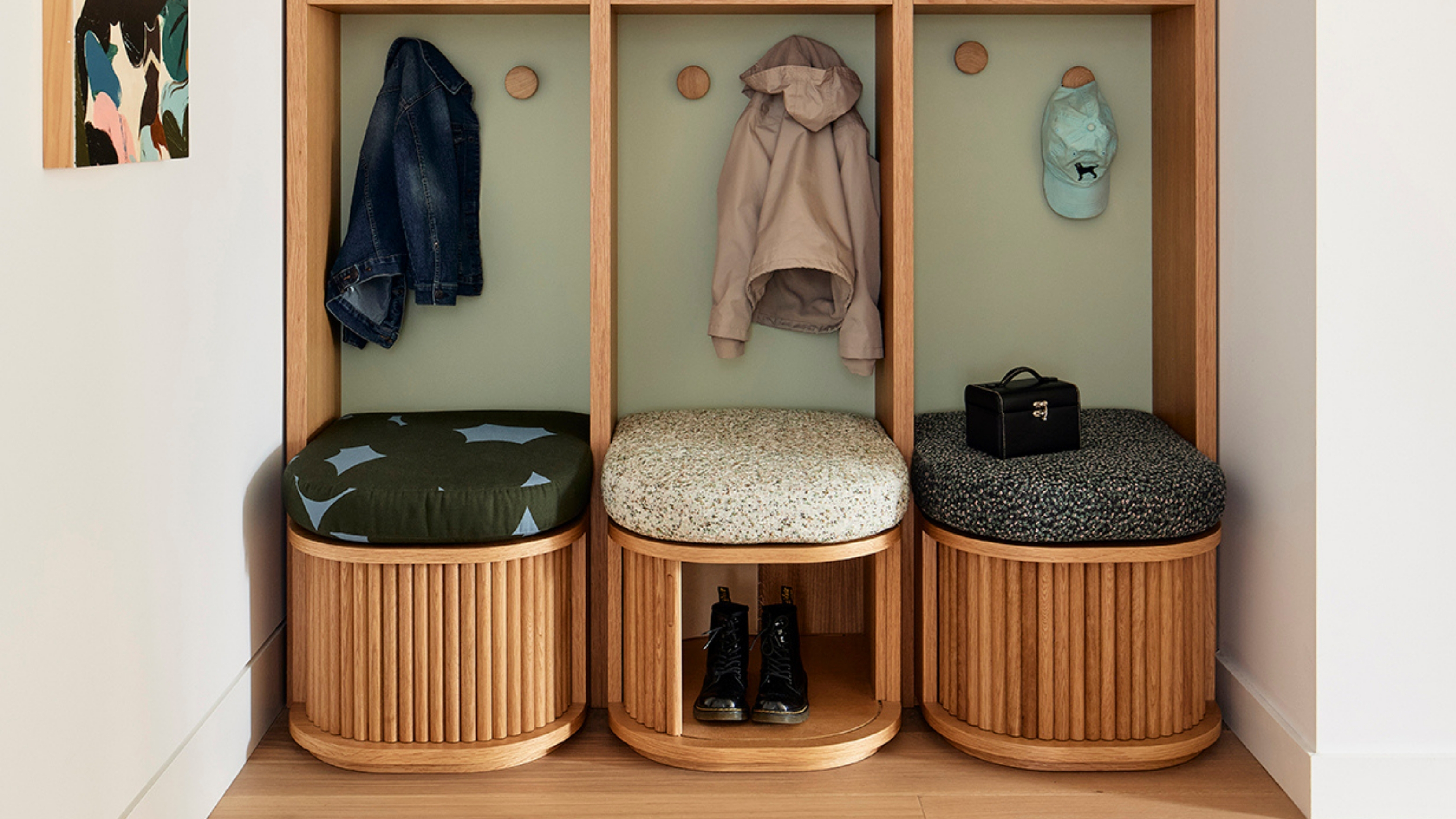 an entryway seating area with tambour doors to hide shoes