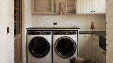 A small mudroom in muted tones, designed in brick and stone