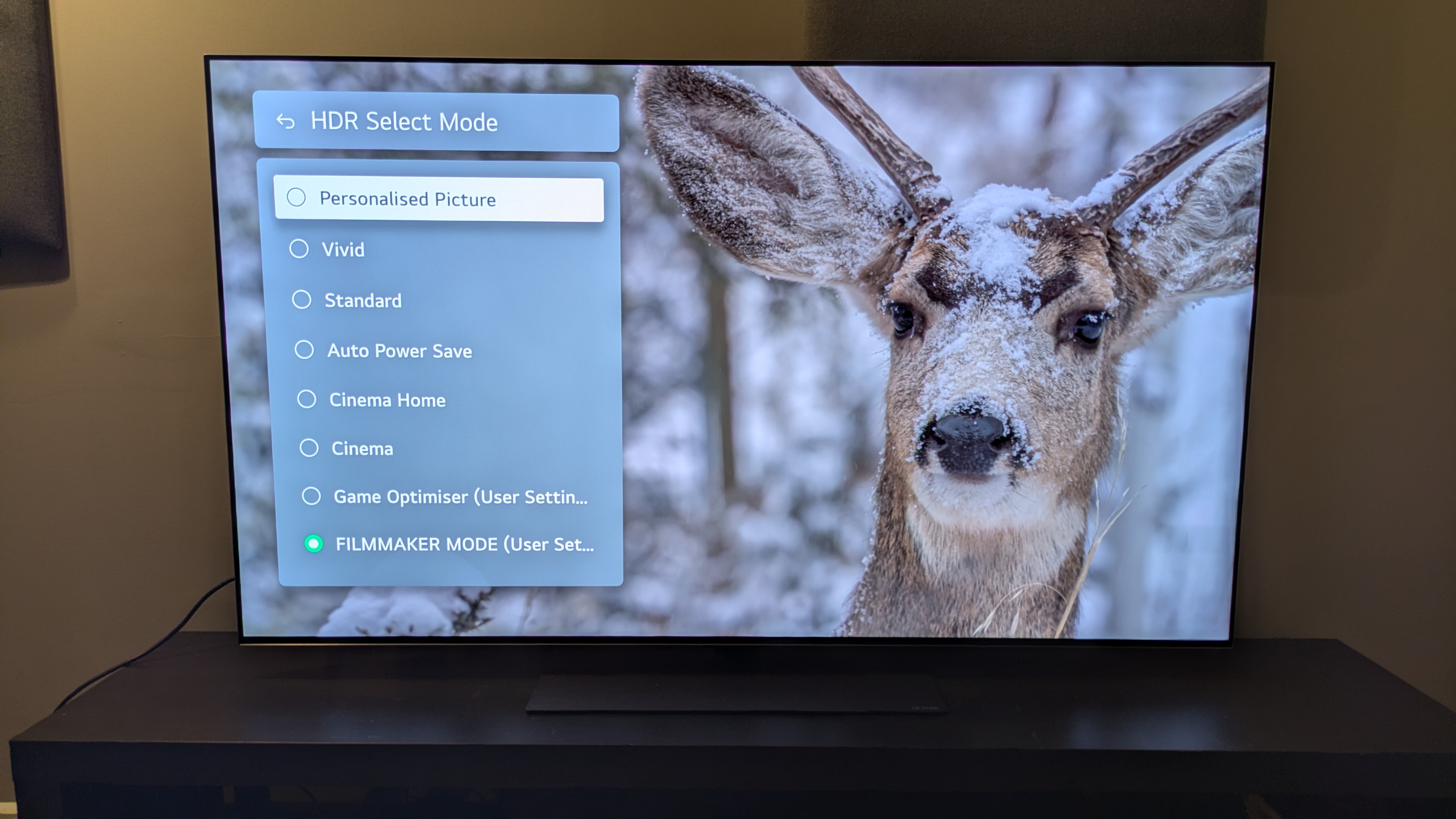 LG G5 OLED TV with picture mode menu on screen over image of snow covered deer