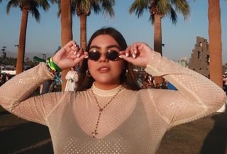 A Coachella influencer is wearing a summer 2024 trend: a mesh dress.