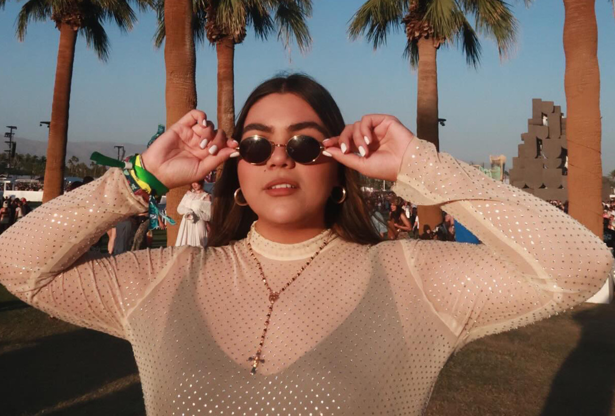 Influencer at Coachella wearing summer 2024 fashion trend, a mesh dress.