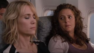 Annie Mumolo looking nervous on the plane next to Kristen Wiig.