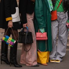 A group of women holding investment handbags