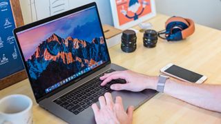 Typing on MacBook on a table