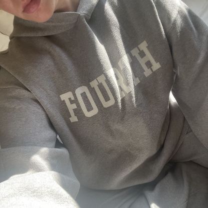 Valeza wearing grey matching loungewear set with spellout across the chest