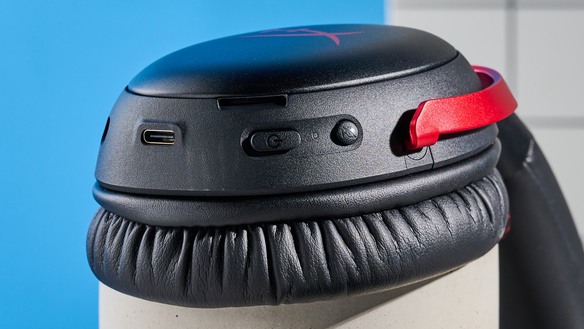 A black and red HyperX Cloud III S Wireless gaming headset
