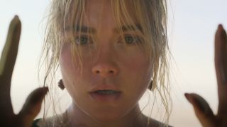 Florence Pugh looking straight ahead in teary panic in Don't Worry Darling.