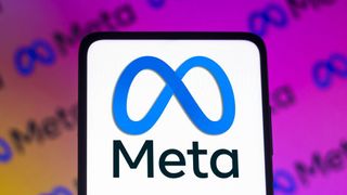 The Meta logo shown on a phone, in front of an orange to purple gradient bearing smaller versions of the logo