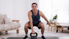 Man performing single-arm kettlebell swings